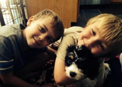 Alek (left), Tyler (right) with their family dog, Breezy.