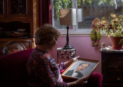 Melissa Stevens holding a photo of her brother Joseph “Jae” Stevens.